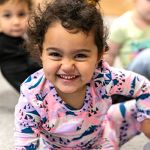 toddler girl smiling at daycare