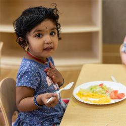 Young girl eating lunch at daycare