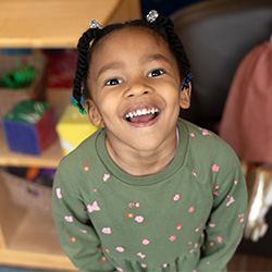 little girl smiling at daycare