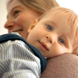 baby with head on teachers shoulder